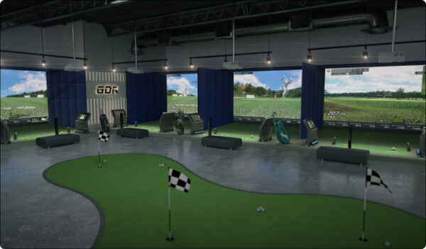 Indoor Golfzon simulator studio with multiple hitting bays and putting greens, designed for player training and virtual rounds—ideal for exploring the top 10 easiest Golfzon courses in a controlled environment.